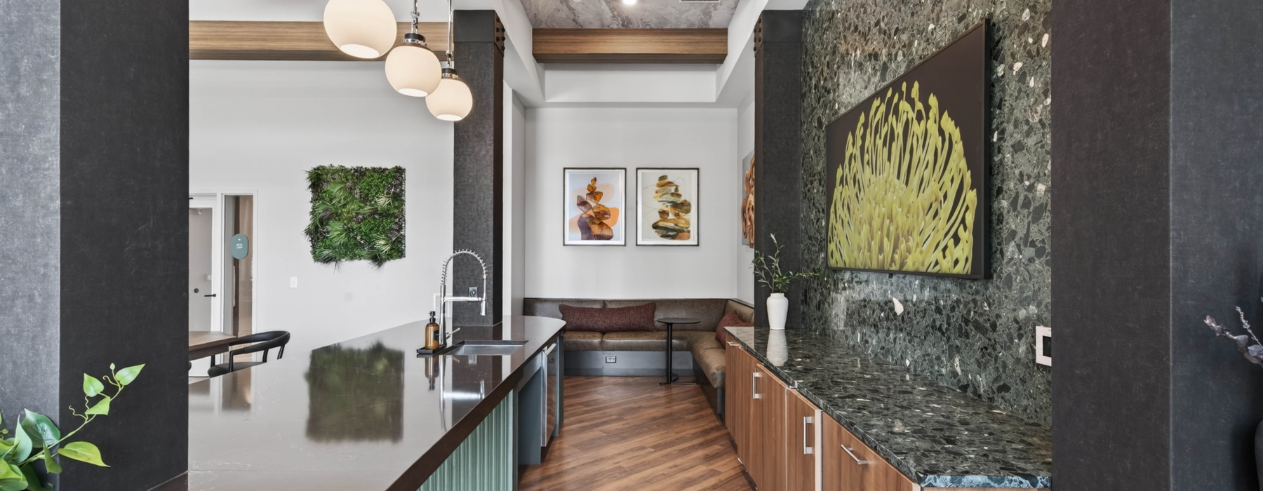 Entertaining space with kitchen island, tv, and banquette seating