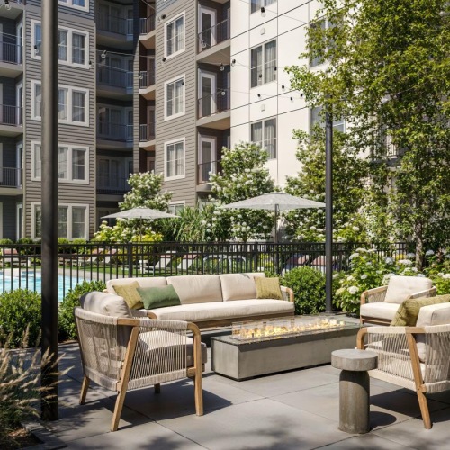 a courtyard with a couches and a firepit